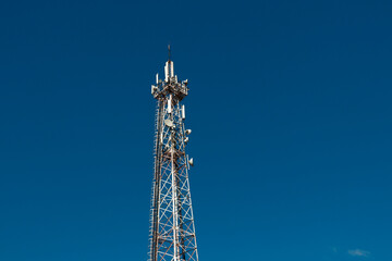 Wall Mural - communication tower against a blue sky