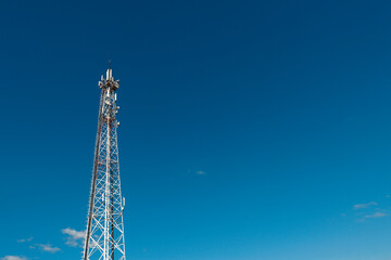 Wall Mural - communication tower against a blue sky