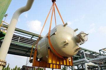 large chemical tank are being lifted up for installation in the chemical plant construction project.