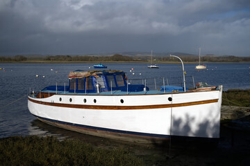 Wall Mural - An Elegant old motor boat moored at Dell Quay England on the estuary.