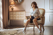 © Smeilov - The girl is sitting on a chair in a short skirt with her legs spread