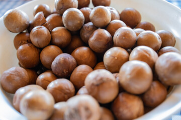 A group of macademia fruits with hard brown shell