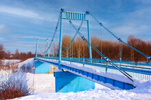 Blue Bridge Over The River In Snow