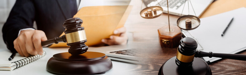 Business and lawyers discussing contract papers with brass scale on desk in office. Law, legal services, advice, justice and law concept picture with film grain effect