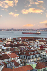 Wall Mural - view of the red roofs of the city and the wide river with a large ship in the capital of Portugal - Lisbon