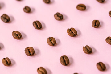 Wall Mural - Medium roast Arabica coffee beans on pink background