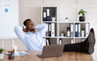 © Prostock-studio - Peaceful black manager listening to music in his office