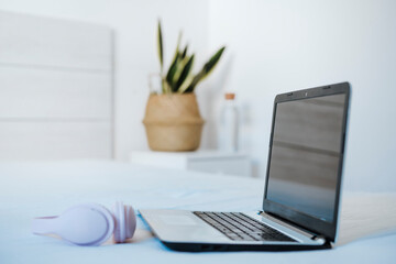 Laptop and headphone kept on table at home