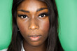 © Giorgio Fochesato/Westend61 - Close-up of woman face against green background