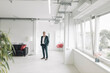 © Westend61 - Businessman with hands in pockets standing at new office