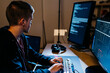 © JOSEP M ROVIROSA/Westend61 - Male hacker looking at computer while working at office