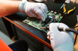 © Westend61 - Technician soldering circuit board of electrical component at workbench in electronics repair shop