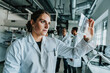 © Mareen Fischinger/Westend61 - Young woman examining human brain slide while standing with coworker in background at laboratory