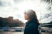 Mid Adult Woman Looking Away While Standing By Road At City