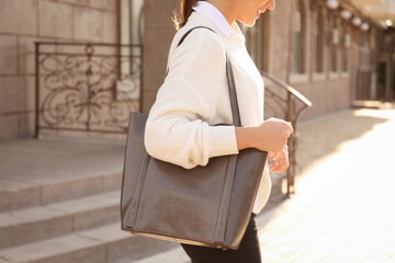 Woman with stylish shopper bag outdoors, closeup