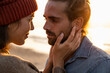 © UWE_UMSTAETTER/Westend61 - Romantic young couple standing face to face during sunset