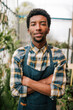 © Lupe Rodriguez/Westend61 - Confident young African male botanist with arms crossed at plant nursery