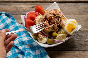 Sticker - Tuna salad with potatoes and boiled egg called nicoise on wooden background