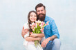 © be free - father and daughter embrace with spring tulip flower bouquet, fathers day