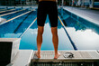 © Westend61 - Young male swimmer standing at poolside