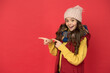 © be free - child in knitted hat and scarf feel cozy. pointing finger on copy space. wear comfortable apparel in cold season. happy teen girl in warm winter clothes. childhood happiness. winter holiday activity