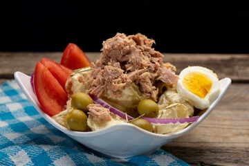 Sticker - Tuna salad with potatoes and boiled egg called nicoise on wooden background