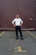 © KNSY/Westend61 - Businessman with hands on hip standing in parking lot