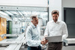 © KNSY/Westend61 - Businessmen discussing over laptop in industry