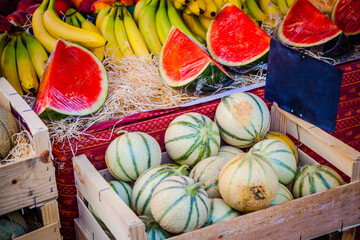 Melons and bananas at a stall in an agricultural market in Provence, France