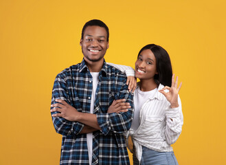 Young cheerful african american female in casual put her hand on guys shoulder