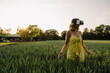© KNSY/Westend61 - Young woman wearing VR goggles in a grain field in the countryside