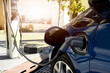 © Tetra Images/Tetra Images - Electric car recharging in charging station