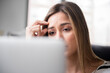 © Jamie Grill/Tetra Images - Worried young woman in front of laptop