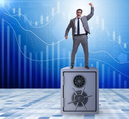 Wall Mural - Excited businessman standing on top of safe