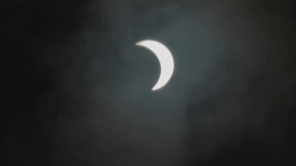 Wall Mural - clouds moving in front of a lunar eclipse moon, dark, black night sky