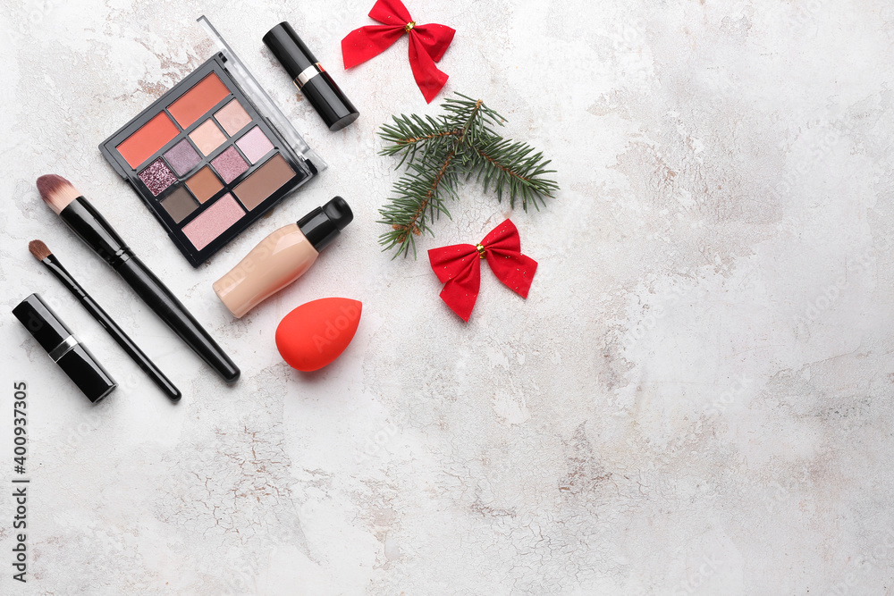 Christmas composition with cosmetics on light background