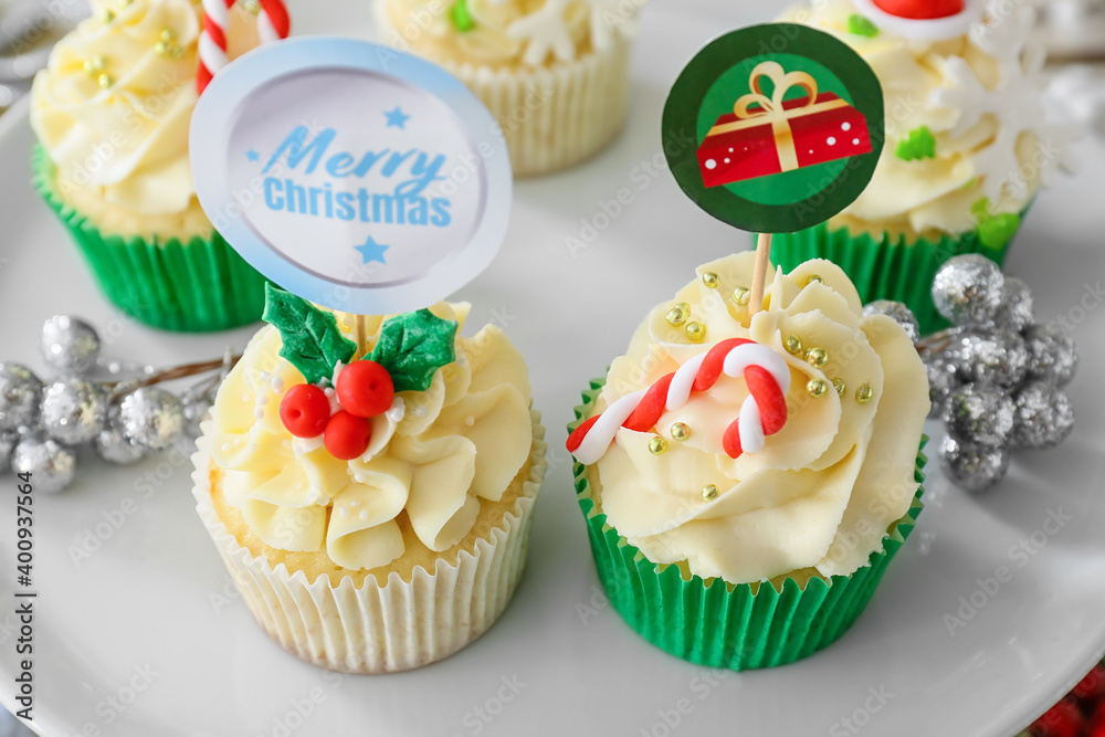 Dessert stand with tasty Christmas cupcakes, closeup