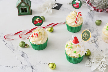 Wall Mural - Composition with tasty Christmas cupcakes on table