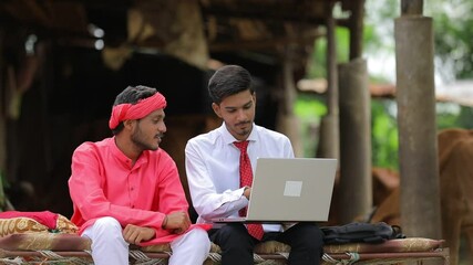 Poster - Young indian agronomist showing some information to farmer in laptop at home