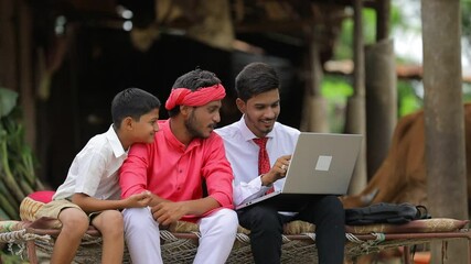 Sticker - Young indian agronomist showing some information to farmer in laptop at home