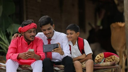 Wall Mural - Young indian agronomist or banker showing some information to farmer in smartphone