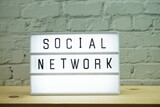 Fototapeta  - Social Network word in light box on wooden background