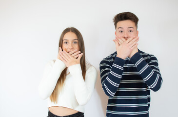 Wall Mural - Couple doing surprise gesture over white background