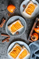Wall Mural - Persimmon puff pastry pies with cinnamon
