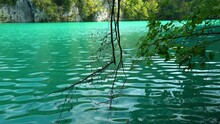 View Across A Turqoise Colored Lake With White Rock Walls In The Background In Plitvice Lakes National Park In Croatia, Europe