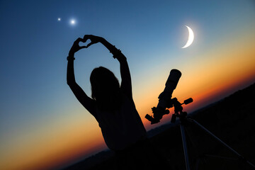 Wall Mural - woman looking at night sky with amateur astronomical telescope.