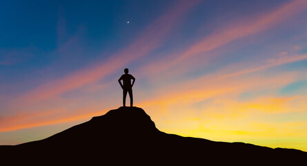 Silhouette of businessman on mountain top over sunset sky background, motivational, business, success, leadership and achievement concept