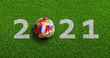 Soccer Ball With Flags Texture On Green Soccer Field And 2021 Numbers	
