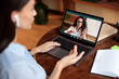 © Prostock-studio - Woman using laptop having online class with teacher, over shoulder