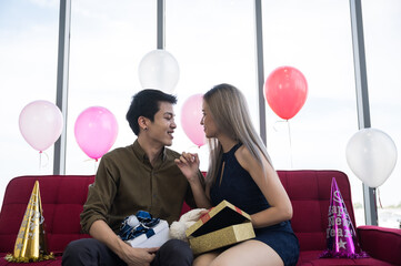 young couple with Christmas gift box presents for Christmas and new years party - 2021